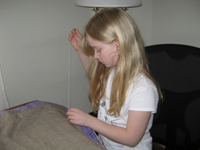 Megan doing hand sewing. (400x300)